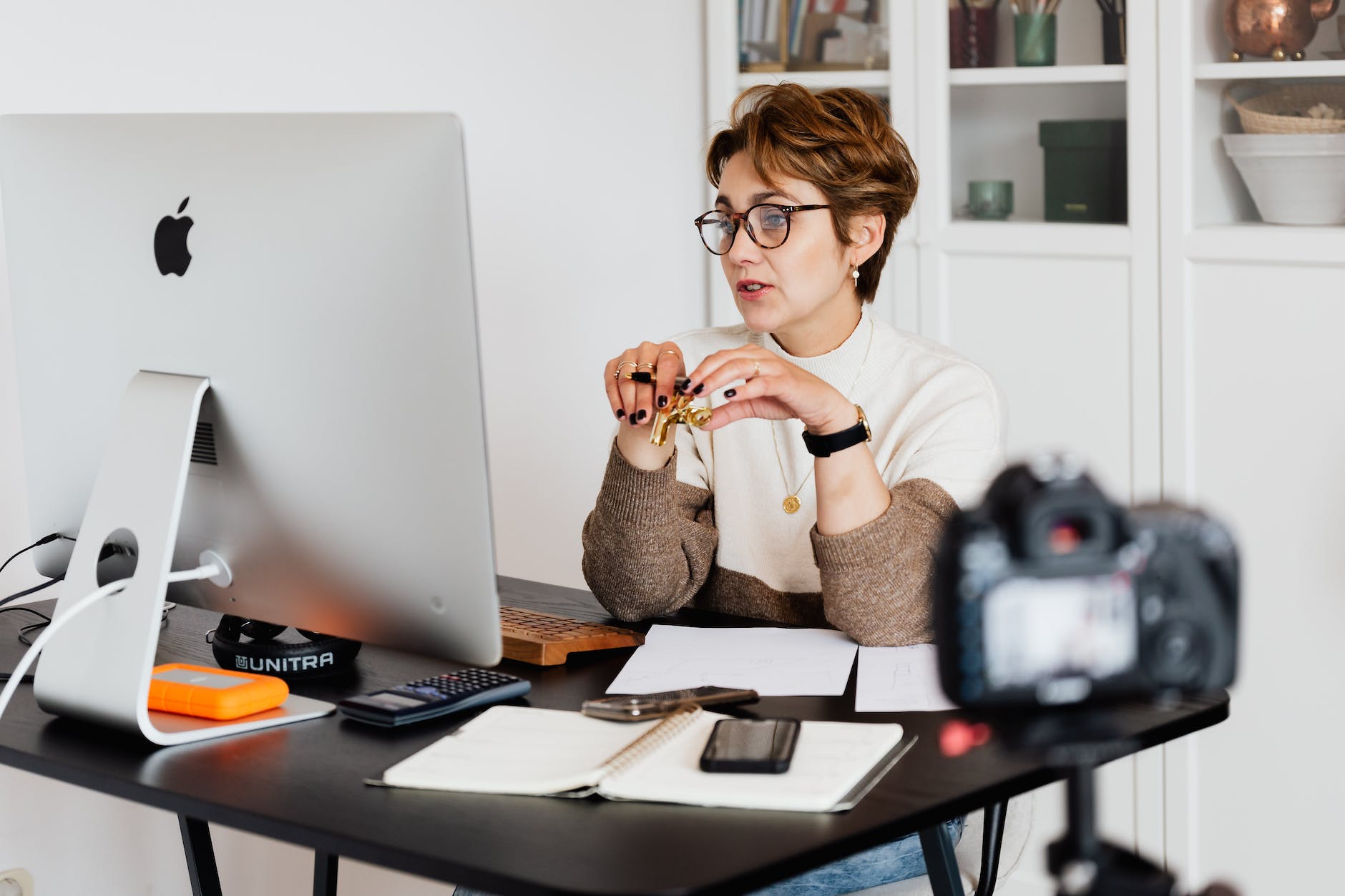 confident elegant lady in eyeglasses following an online lesson